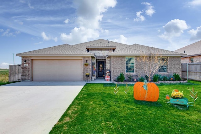 view of front of property featuring a front yard and a garage