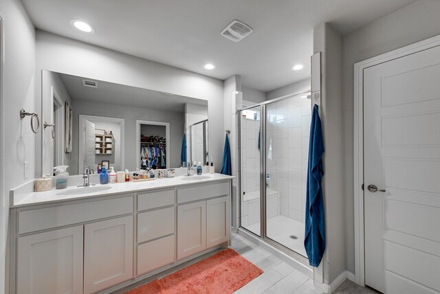 bathroom with wood-type flooring, vanity, and walk in shower