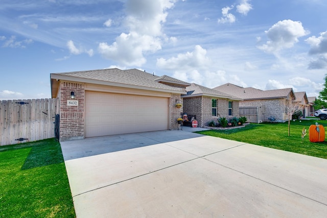 ranch-style home with a garage and a front lawn