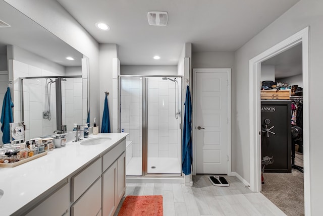 bathroom with vanity and a shower with shower door