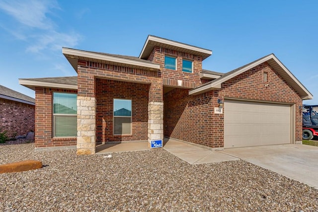 view of front of house featuring a shingled roof, concrete driveway, brick siding, and a garage