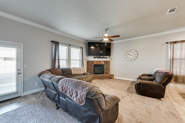 tiled living area featuring a fireplace, a ceiling fan, ornamental molding, visible vents, and baseboards