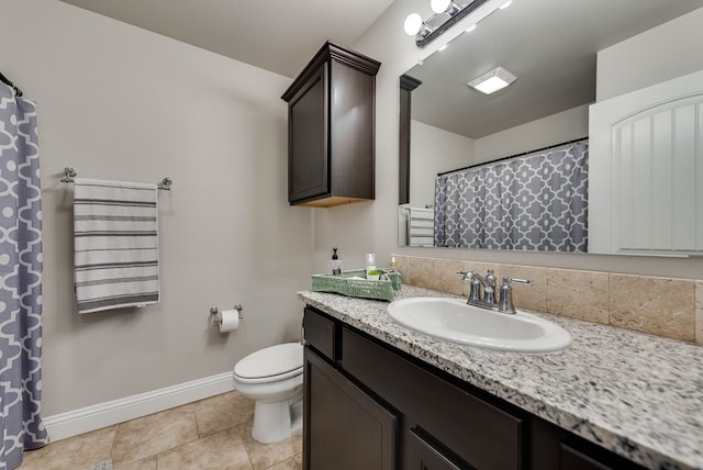 full bath featuring baseboards, tile patterned flooring, vanity, and toilet