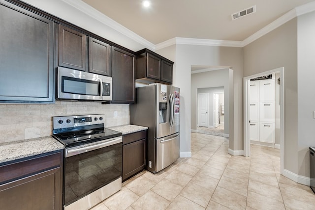 kitchen featuring tasteful backsplash, visible vents, dark brown cabinetry, crown molding, and stainless steel appliances