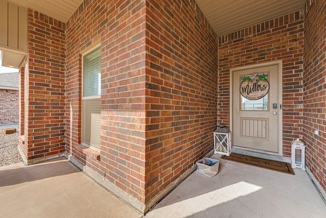 doorway to property with brick siding