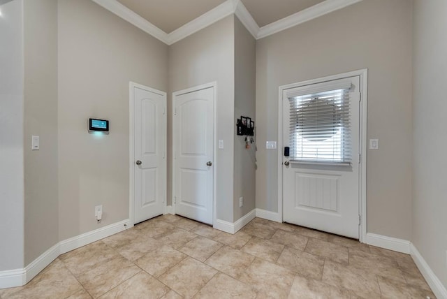 foyer entrance featuring baseboards and crown molding
