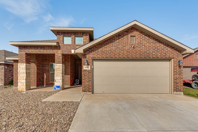 view of front of home with brick siding, driveway, and an attached garage