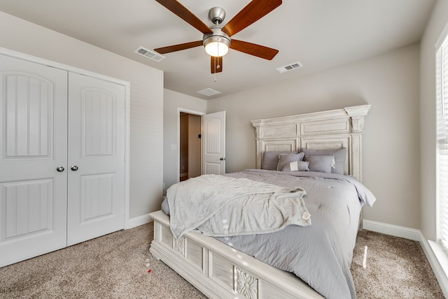 bedroom with visible vents, a closet, and carpet floors