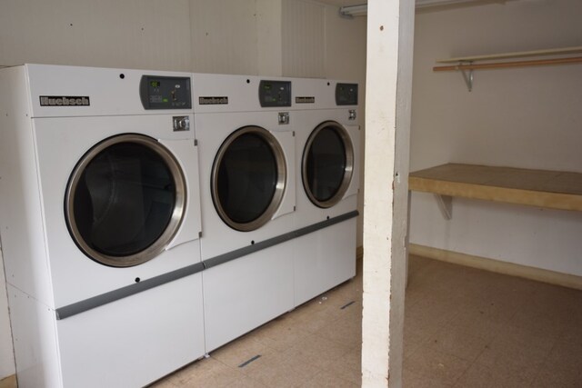 community laundry room with independent washer and dryer and light flooring