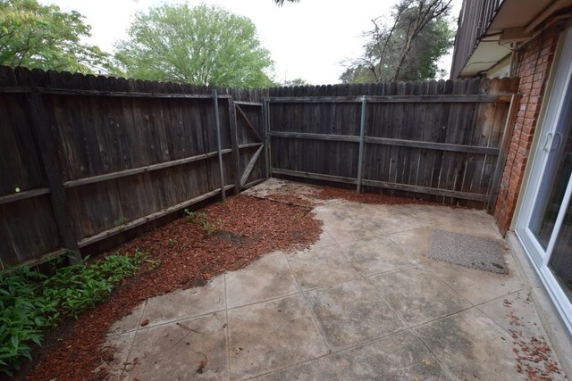 fenced backyard with a patio area