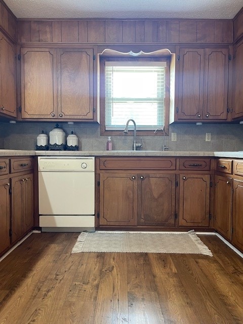 4500 El Paso, Snyder, TX 79549 - kitchen with white dishwasher, dark wood-style floors, light countertops, and decorative backsplash