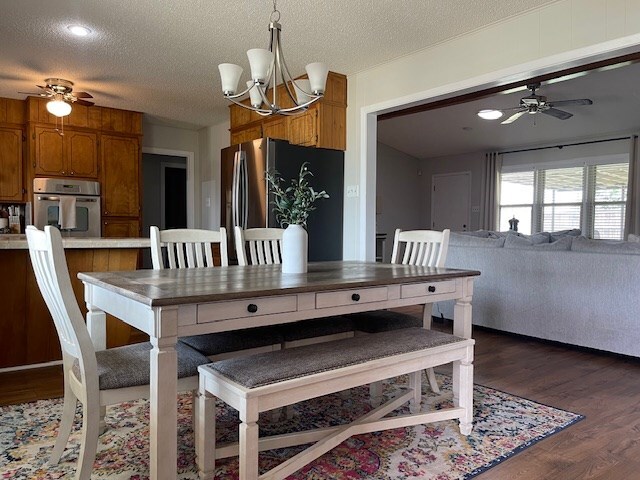 4500 El Paso, Snyder, TX 79549 - dining space with a ceiling fan, a chandelier, wood finished floors, and a textured ceiling