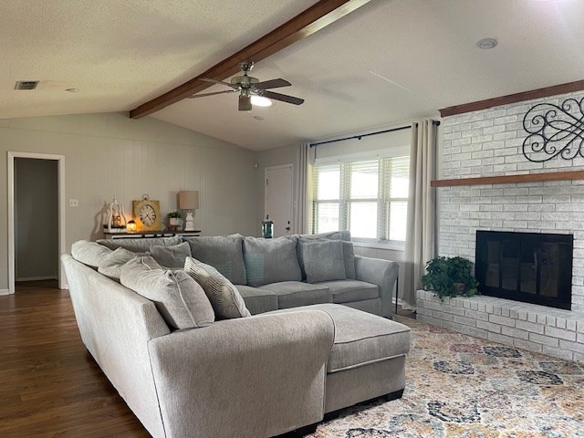 4500 El Paso, Snyder, TX 79549 - living room featuring a ceiling fan, dark wood finished floors, and a fireplace