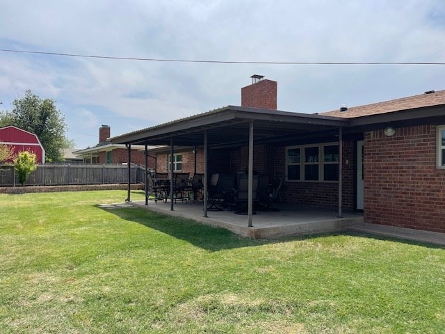 4500 El Paso, Snyder, TX 79549 - back of property with a patio area, a chimney, and brick siding