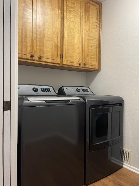 4500 El Paso, Snyder, TX 79549 - laundry area with separate washer and dryer, cabinet space, and wood finished floors