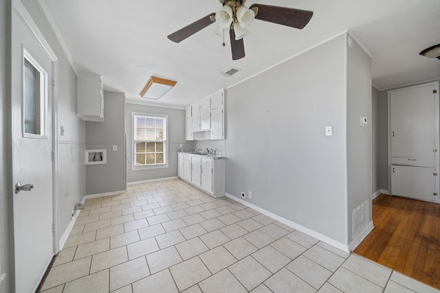 1309 Marijo, Big Spring, TX 79720 - spare room featuring a ceiling fan, crown molding, and light tile patterned floors