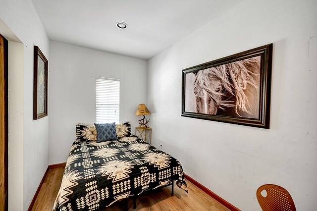 2309 W Golf Course Rd, Midland, TX 79701 - bedroom featuring baseboards and wood finished floors