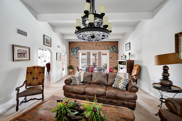 2309 W Golf Course Rd, Midland, TX 79701 - carpeted living area with an inviting chandelier, beam ceiling, visible vents, baseboards, and arched walkways