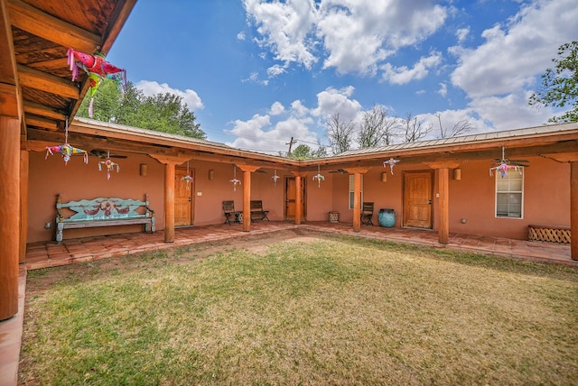 2309 W Golf Course Rd, Midland, TX 79701 - back of house with a lawn, a patio, and stucco siding