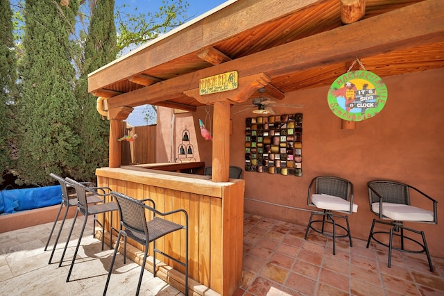 2309 W Golf Course Rd, Midland, TX 79701 - bar with wood ceiling, stone tile floors, beam ceiling, and indoor bar