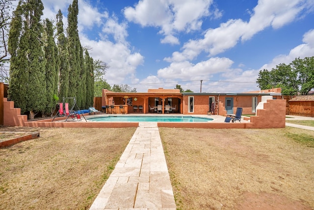 2309 W Golf Course Rd, Midland, TX 79701 - pool with a patio, fence, and a lawn