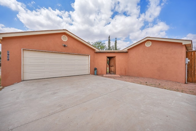 2309 W Golf Course Rd, Midland, TX 79701 - single story home featuring stucco siding, concrete driveway, and an attached garage