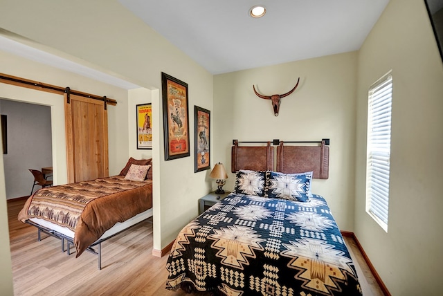 2309 W Golf Course Rd, Midland, TX 79701 - bedroom featuring light wood-type flooring, baseboards, and multiple windows