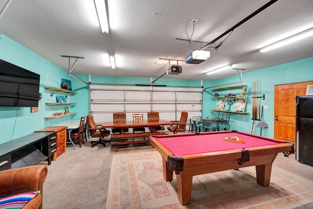 2309 W Golf Course Rd, Midland, TX 79701 - recreation room featuring a garage, concrete floors, pool table, and a textured ceiling