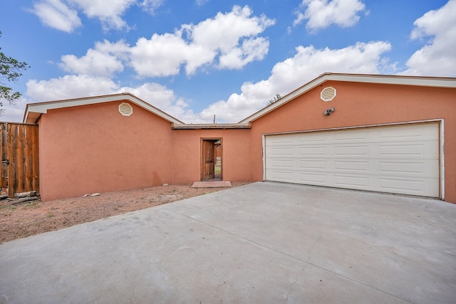 2309 W Golf Course Rd, Midland, TX 79701 - ranch-style home featuring stucco siding, fence, concrete driveway, and a garage