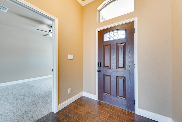 foyer entrance with a ceiling fan, dark wood-style floors, baseboards, and visible vents