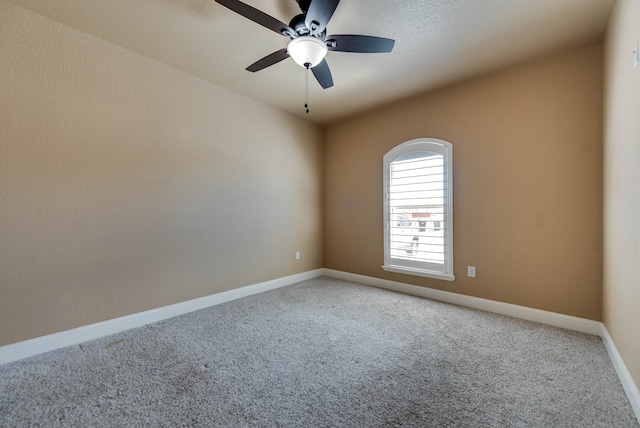 unfurnished room with light carpet, baseboards, and a ceiling fan