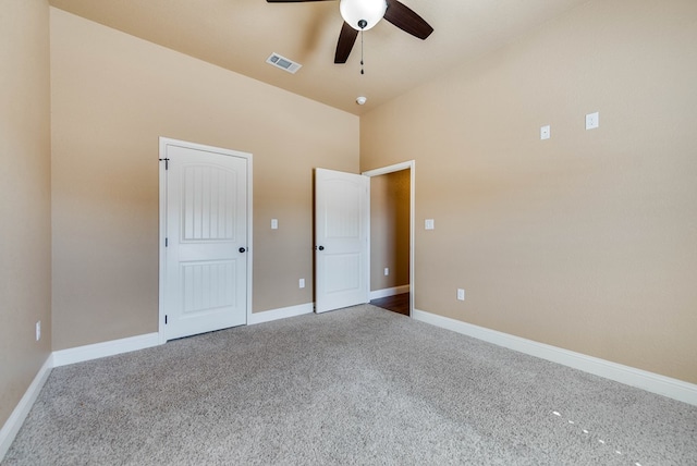 unfurnished bedroom with baseboards, carpet flooring, visible vents, and a ceiling fan