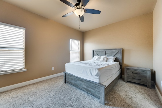 carpeted bedroom with baseboards and a ceiling fan