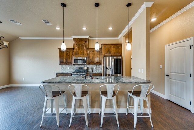 kitchen with a breakfast bar area, dark wood finished floors, decorative backsplash, visible vents, and appliances with stainless steel finishes