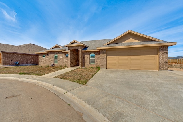 ranch-style house with brick siding, concrete driveway, a shingled roof, and an attached garage