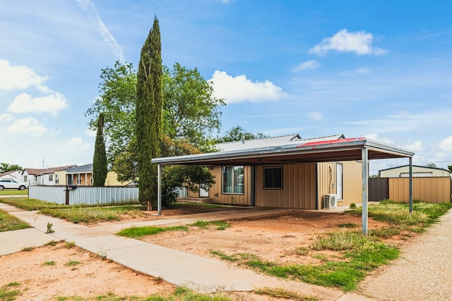 904 E Hester St, Brownfield, TX 79316 - view of front of property featuring an attached carport, fence, dirt driveway, ac unit, and metal roof