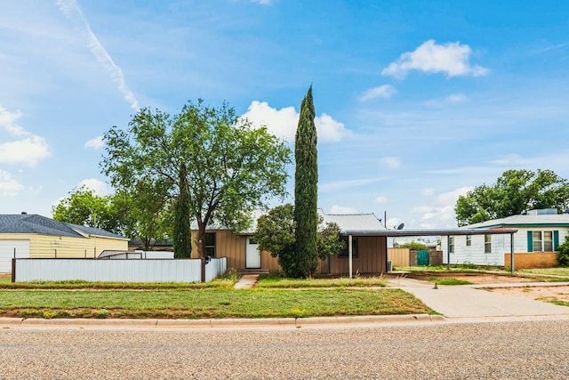 904 E Hester St, Brownfield, TX 79316 - view of front of property featuring concrete driveway, an attached carport, and board and batten siding