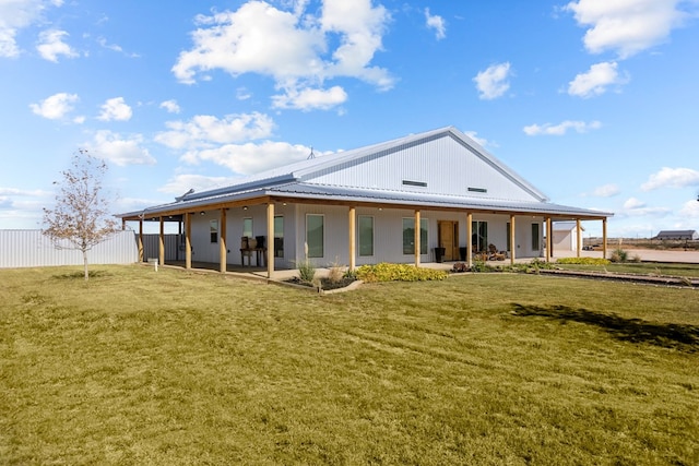 back of property featuring a lawn and a patio area