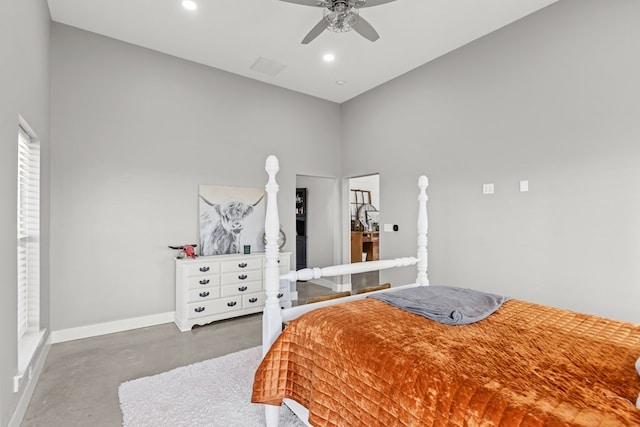 bedroom featuring ceiling fan and a towering ceiling