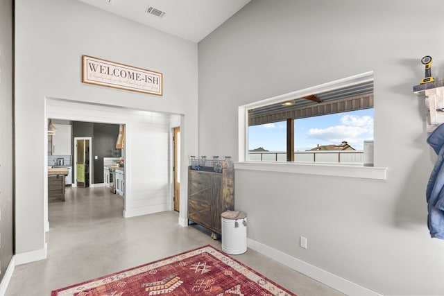 foyer entrance featuring concrete floors