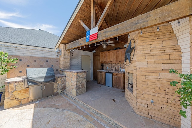 view of patio / terrace with ceiling fan and exterior kitchen