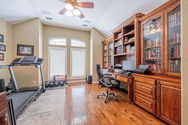 office with a ceiling fan, visible vents, wood finished floors, and lofted ceiling
