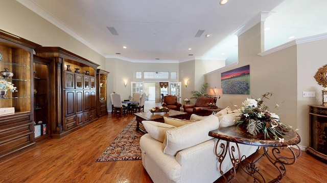 living room featuring crown molding, recessed lighting, baseboards, and wood finished floors