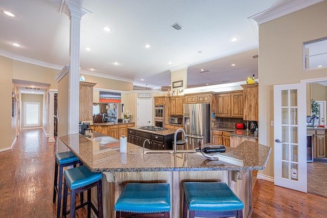 kitchen with crown molding, visible vents, stone countertops, french doors, and appliances with stainless steel finishes