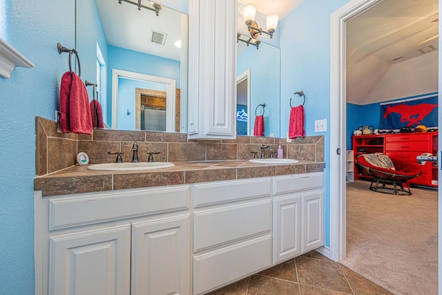 full bathroom with a sink, tile patterned floors, double vanity, and visible vents
