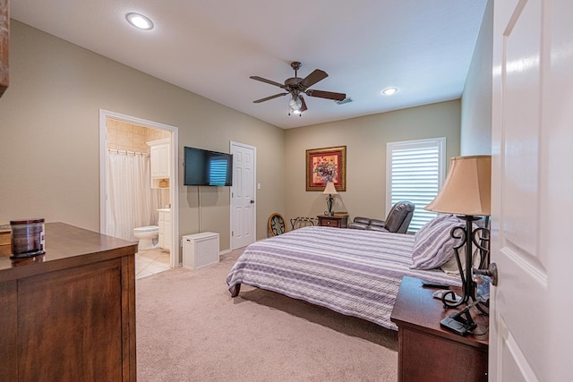 bedroom featuring light colored carpet, recessed lighting, a ceiling fan, and ensuite bath