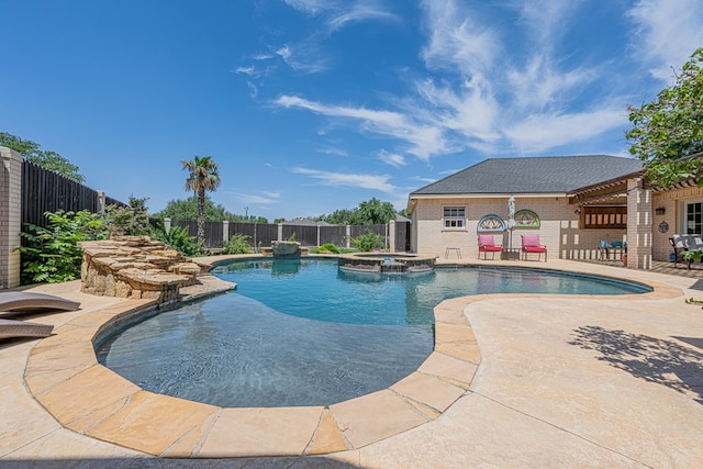 view of swimming pool with a patio, a fenced backyard, and a pool with connected hot tub