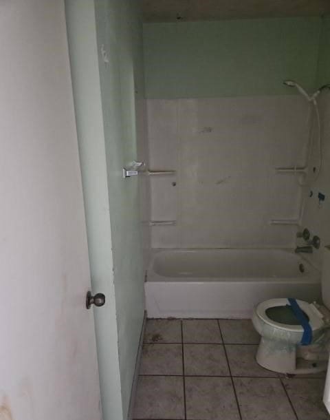 bathroom with toilet, tile patterned floors, and shower / bathtub combination