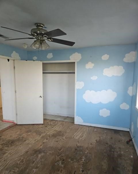 unfurnished bedroom featuring wood-type flooring, a closet, and ceiling fan