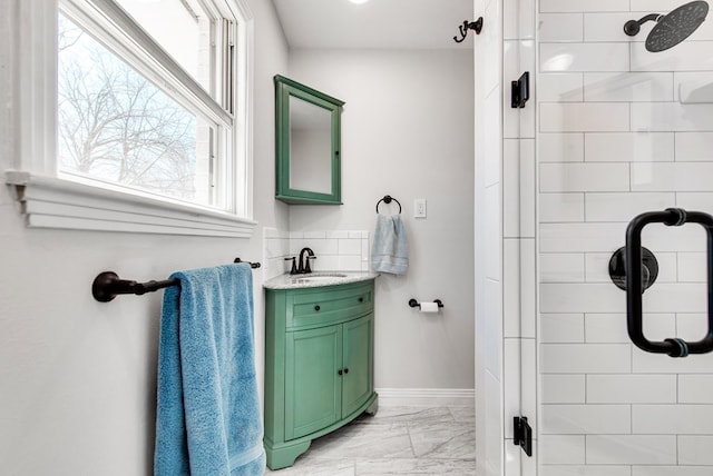 bathroom featuring vanity and an enclosed shower